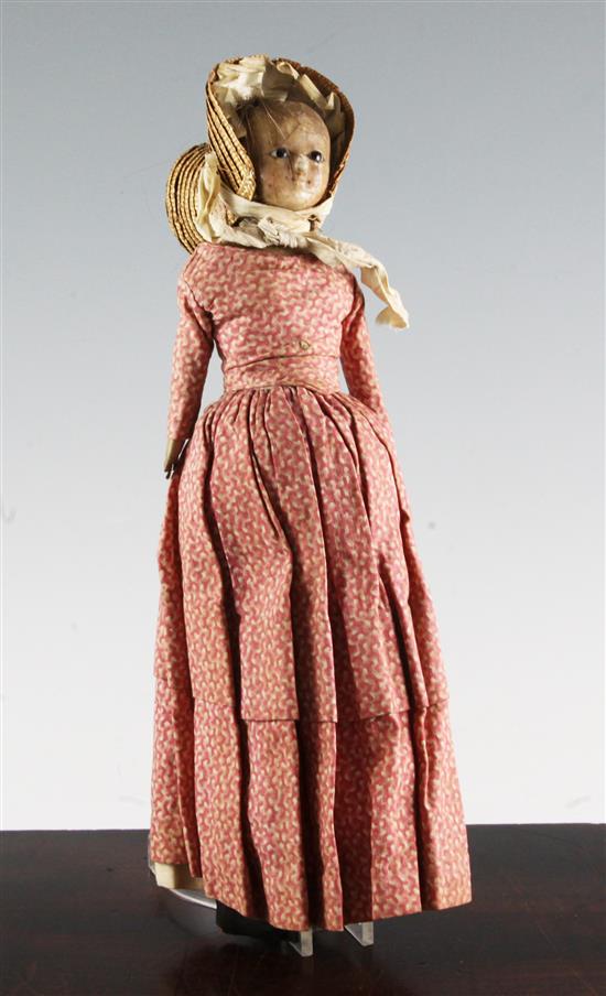 An early 19th century poured wax head and shoulder doll, 14in.